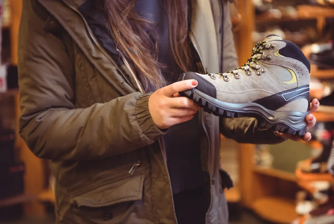 woman holding Puma Safety Shoes for further inspection