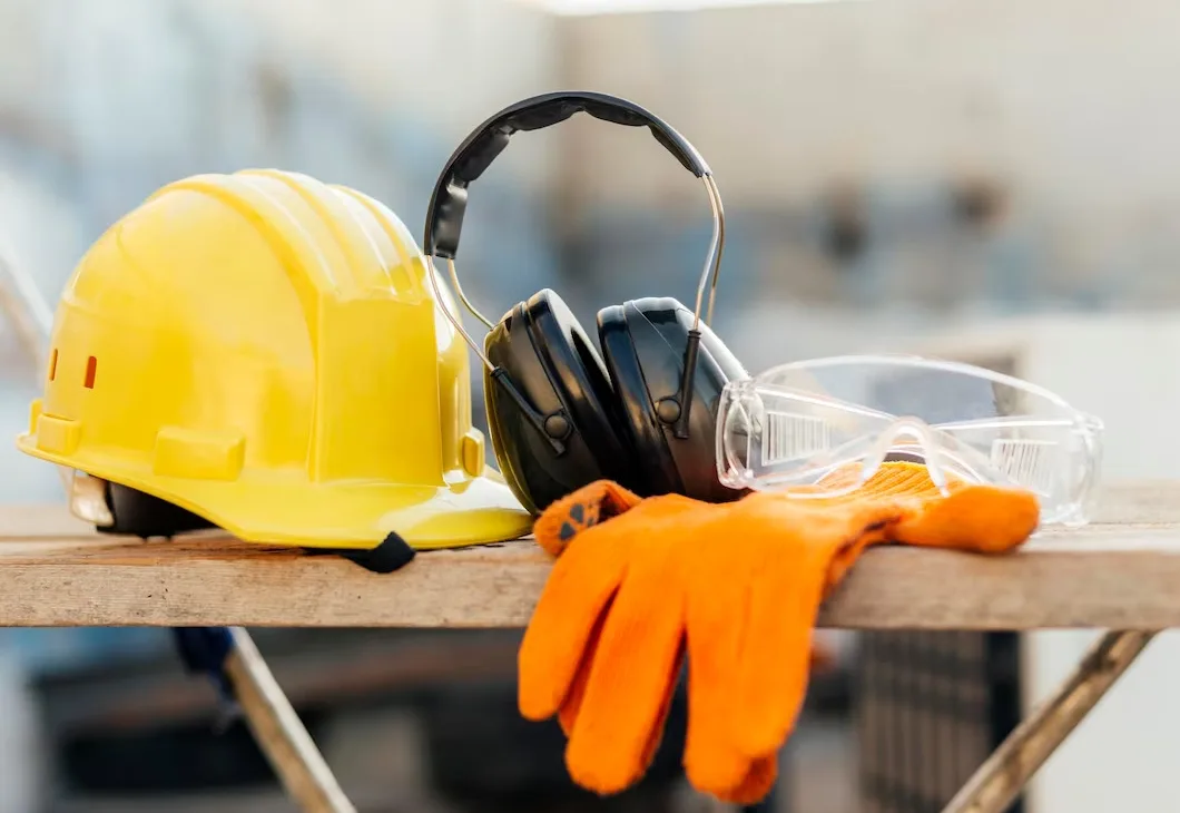 safety gear and equipment on a wooden table at a construction site