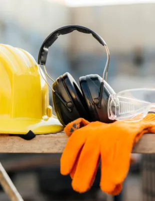 safety gear and equipment on a wooden table at a construction site
