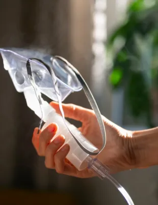 man using nebulizer as an oxygen concentrator