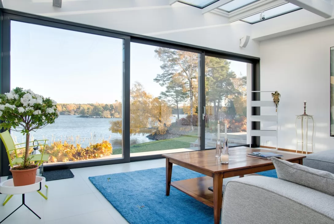 living room with a suspended sliding door showing a view of the outside