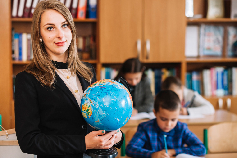 a teacher holding a globe in an international school