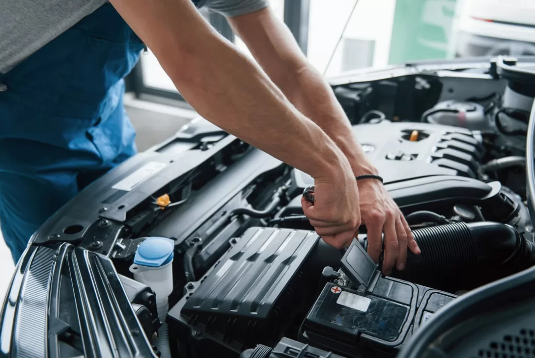 car mechanic conducting engine maintenance and service in workshop