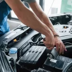 car mechanic conducting engine maintenance and service in workshop