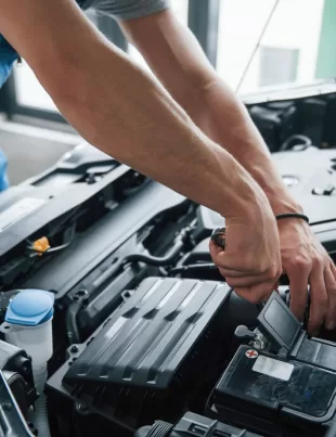 car mechanic conducting engine maintenance and service in workshop