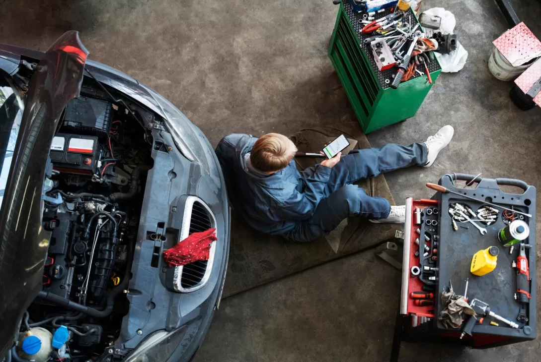 top view of man performing luxury car maintenance at workshop in Shah Alam