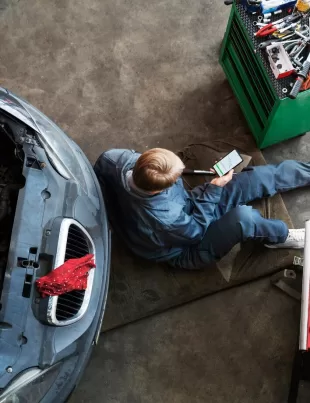 top view of man performing luxury car maintenance at workshop in Shah Alam