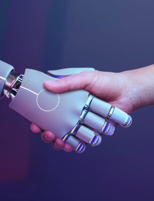 artificial intelligence robot shaking a human's hand