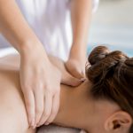 a woman giving her customer a back therapy massage