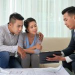 A construction consultant with his clients reviewing documents