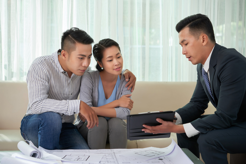 A construction consultant with his clients reviewing documents