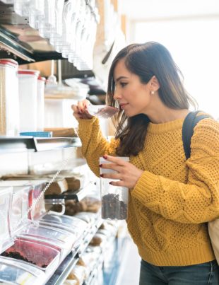 A female looking through groceries at the snack display rack