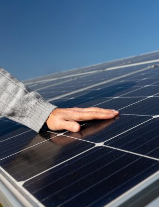 A technician making sure the solar panels are maintained