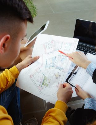Two workers discussing data developments