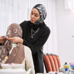 A stylist demonstrating the best shawl to style for the perfect Raya look.