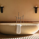 An exquisitely crafted standalone bath tub set against a neutral background.
