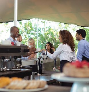 Catering staff serving meals to guests at a corporate event space in Subang Jaya.
