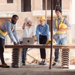 A group of workers discuss how to enhance the worksite needs for cabins and smart updates.