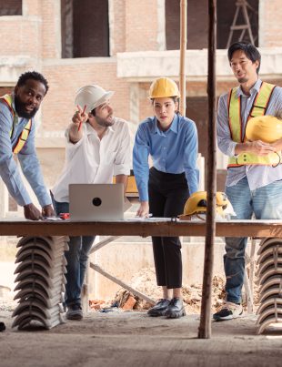 A group of workers discuss how to enhance the worksite needs for cabins and smart updates.