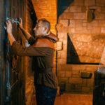 Man trying to solve immersive escape game room