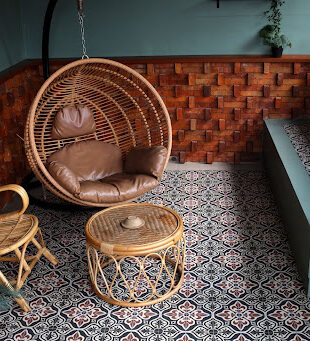Stylish patio with patterned floor tiles and wooden wall panels, reflecting modern design trends and wall and floor tiles price in Malaysia