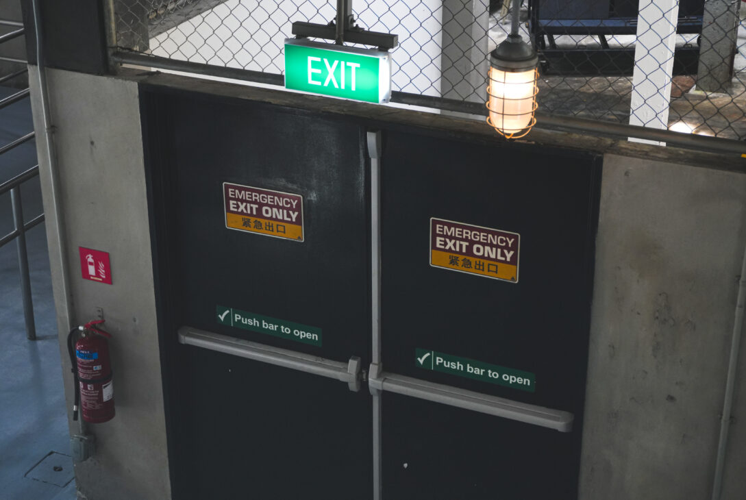 Fire rated emergency exit door with push bar in a commercial building, supplied by a fire rated door supplier in Malaysia. Available from a trusted building material supplier in Selangor.