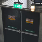 Fire rated emergency exit door with push bar in a commercial building, supplied by a fire rated door supplier in Malaysia. Available from a trusted building material supplier in Selangor.