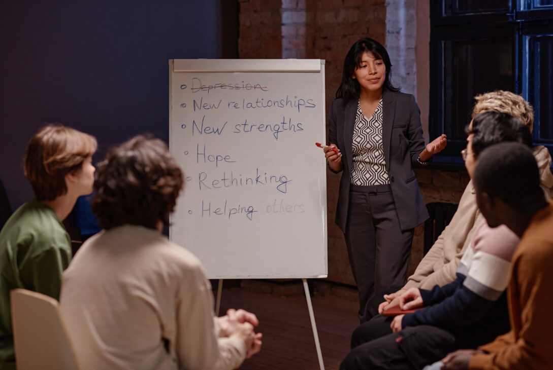 A group mental fitness workshop in Singapore with a facilitator leading a discussion on hope, resilience, and rethinking after depression