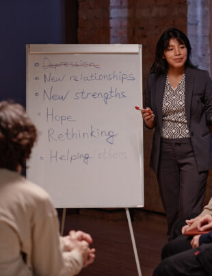 A group mental fitness workshop in Singapore with a facilitator leading a discussion on hope, resilience, and rethinking after depression