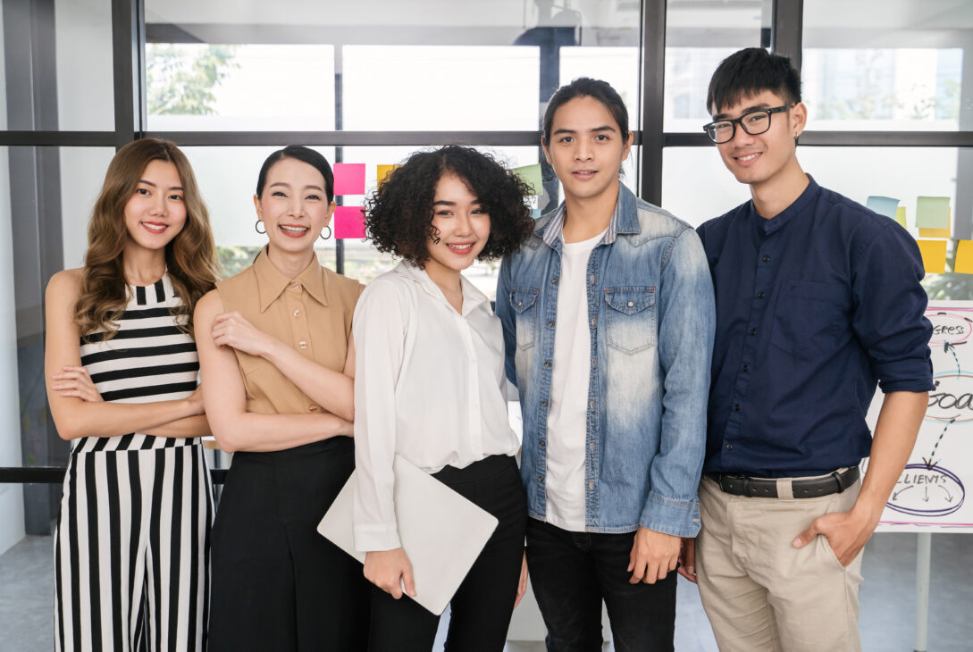 A diverse team of young professionals in Singapore promoting workplace mental health and employee wellbeing