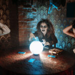 Friends working together to solve eerie clues in a scary escape room with a mystery escape room theme