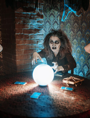 Friends working together to solve eerie clues in a scary escape room with a mystery escape room theme